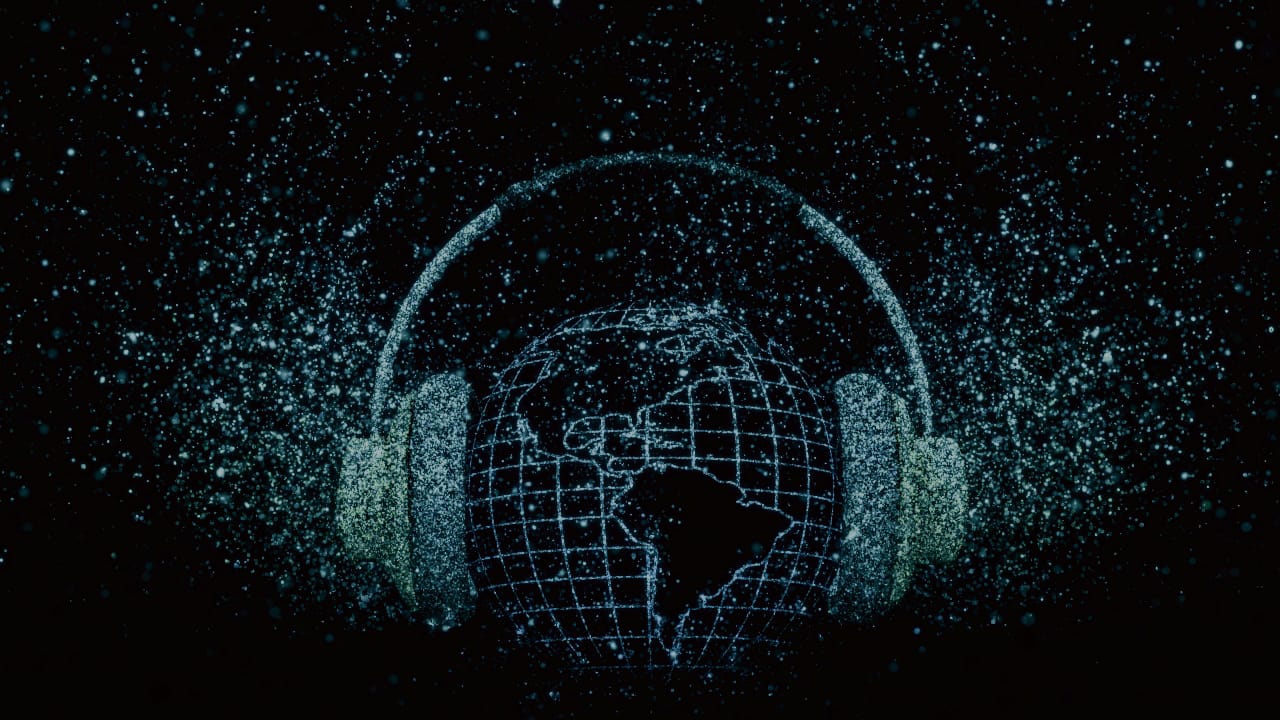 Background image showing glowing headphones and globe digital background with greenish particles on black